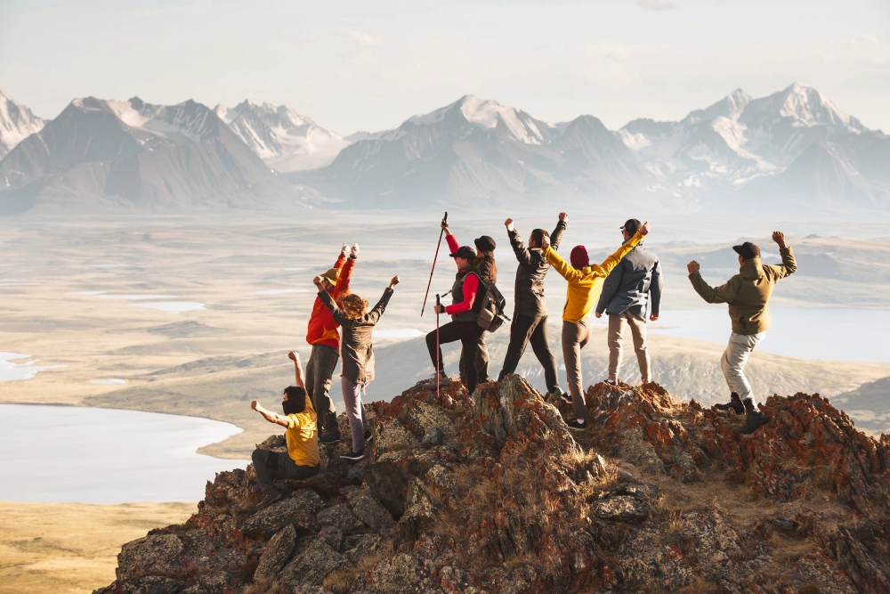 A group of people standing on top of a mountain.