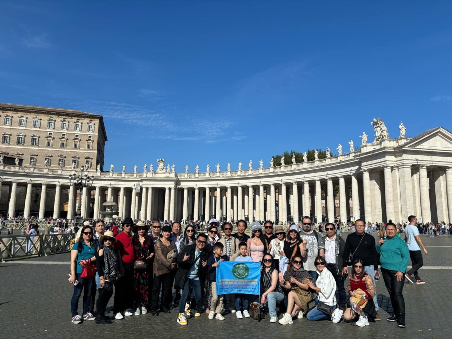 A group of people standing in front of the vatican.