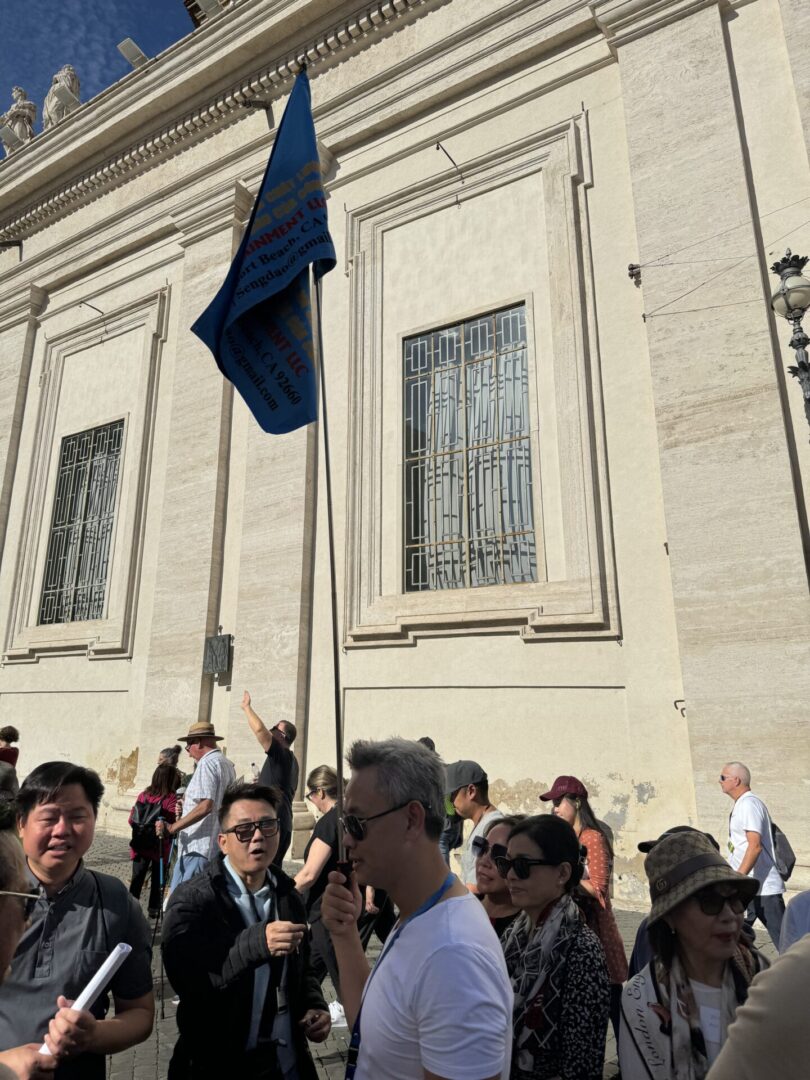 A crowd of people standing in front of a building.