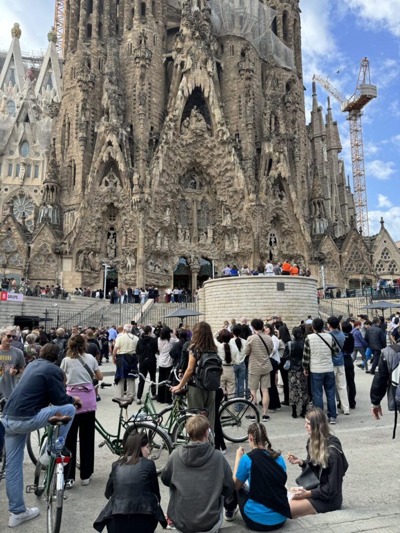 A crowd of people standing around in front of a cathedral.