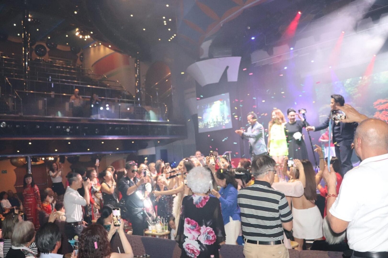 A crowd of people in a room with lights.